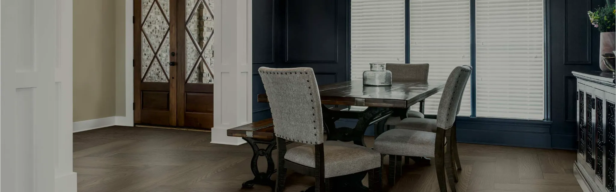 Dining room with wood floors and blinds on 3 large windows